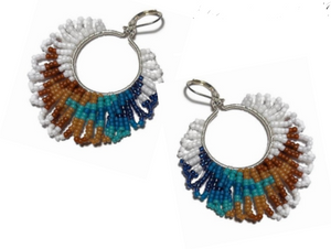 Beaded earrings with blue, brown, and white fringe on a white background