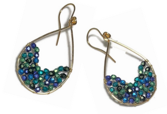 Gold earrings with blue and green beads on a white background