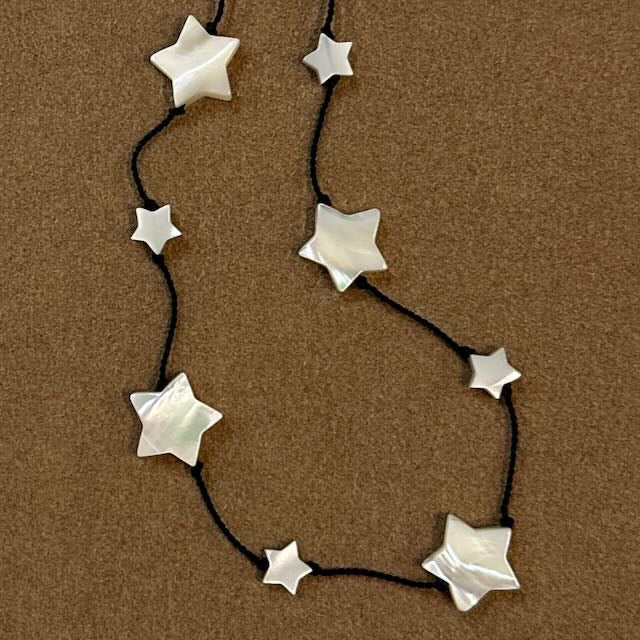 Star-shaped necklace on a brown background